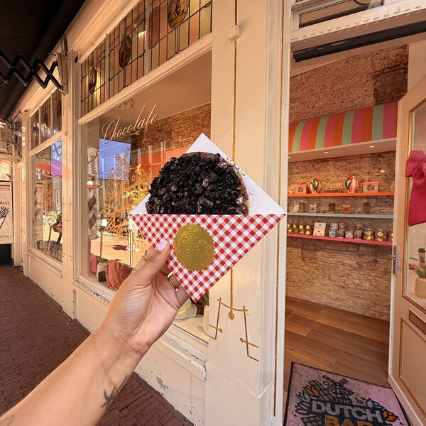 The shop entrance on the Heiligeweg with the Dutch Bar windmill doormat, the gold Chocolate lettering on the window and the striped awning over the shelves inside